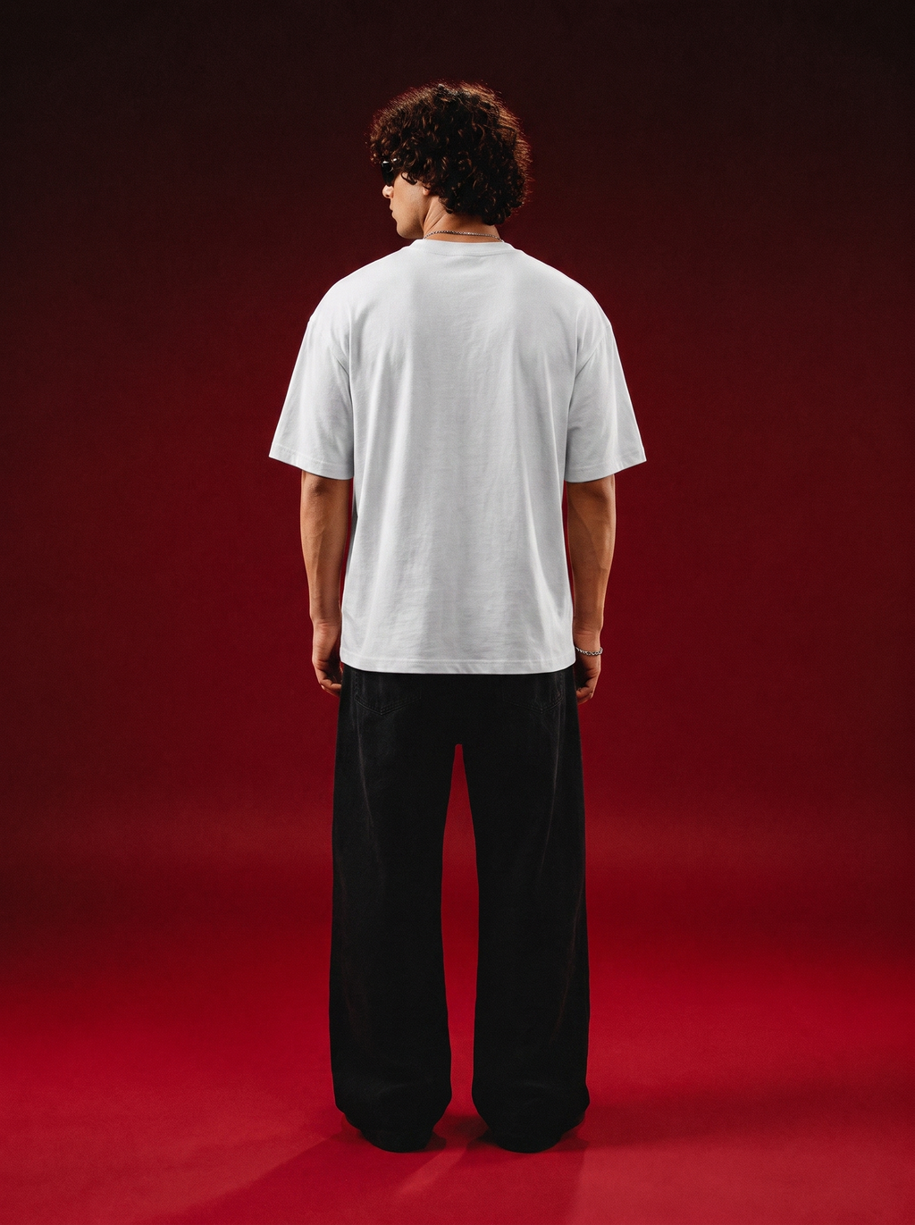Back view of a model wearing a white Spider-Man and Venom graphic T-shirt from BLCKLST
