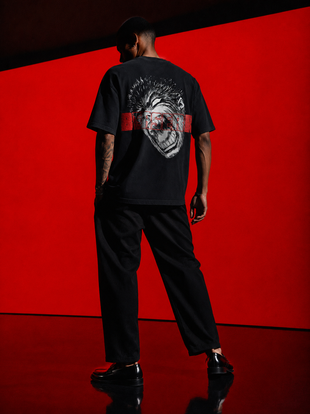 Black Berserk Fan graphic t-shirt with large manga-inspired back print and red Berserk lettering, full-body model