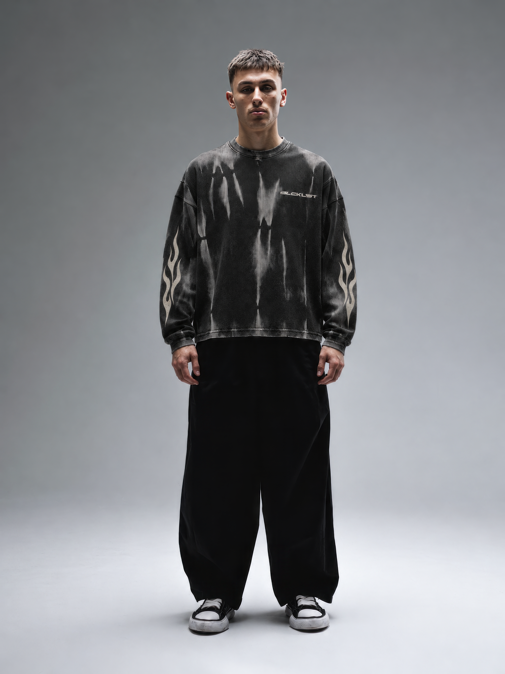 BLCKLST Forge Hammer Wash Waffle Full Sleeve T-Shirt 240 GSM, oversized black washed waffle tee with grey distressed finish and tribal flame sleeve prints, front view.