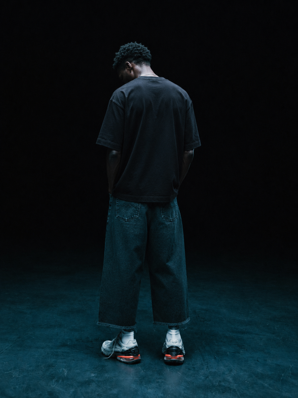 Black 220 GSM oversized t-shirt with plain back, full-body model wearing the shirt