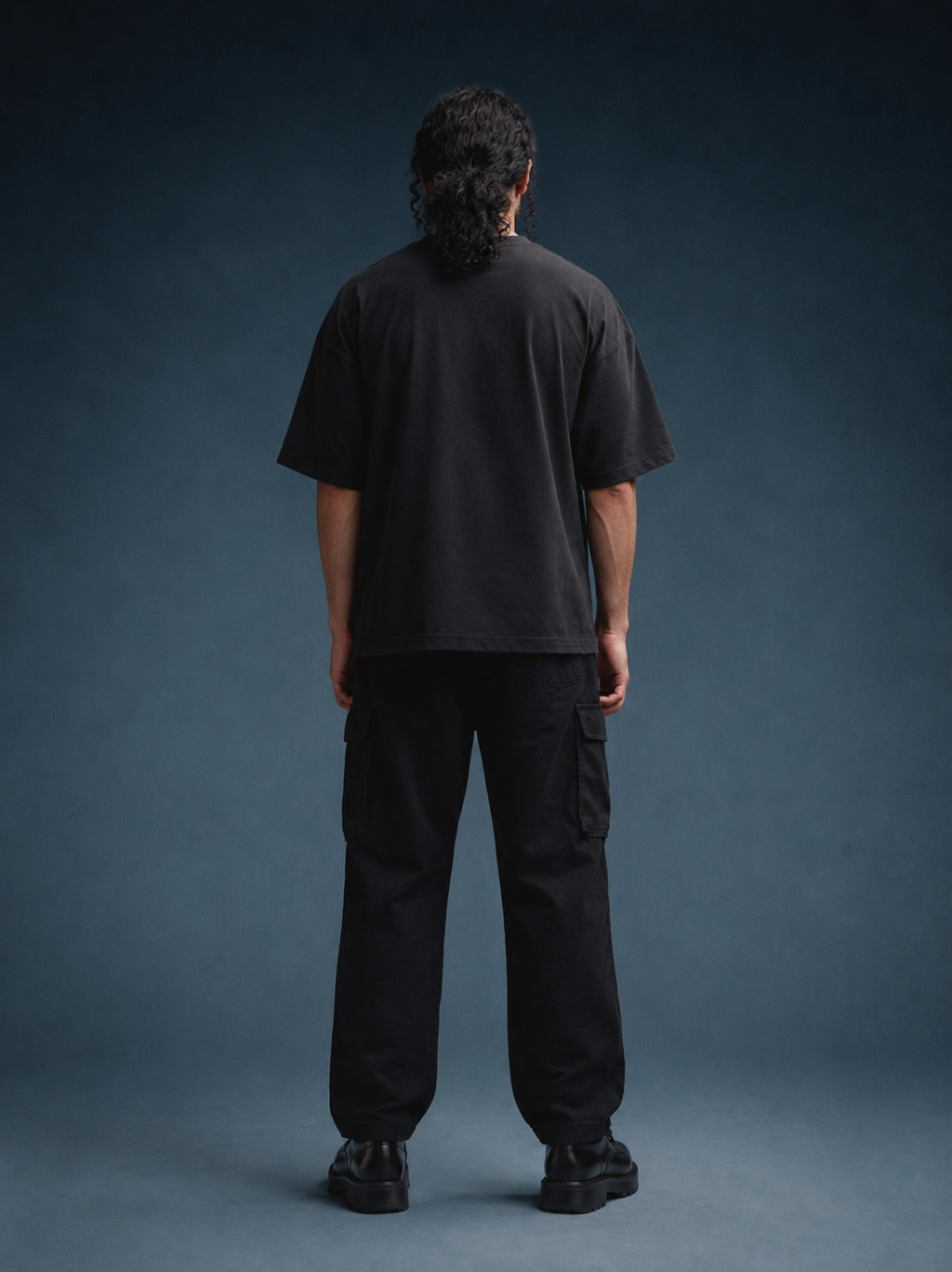 Fly Me black oversized T-shirt shown from the back on a model