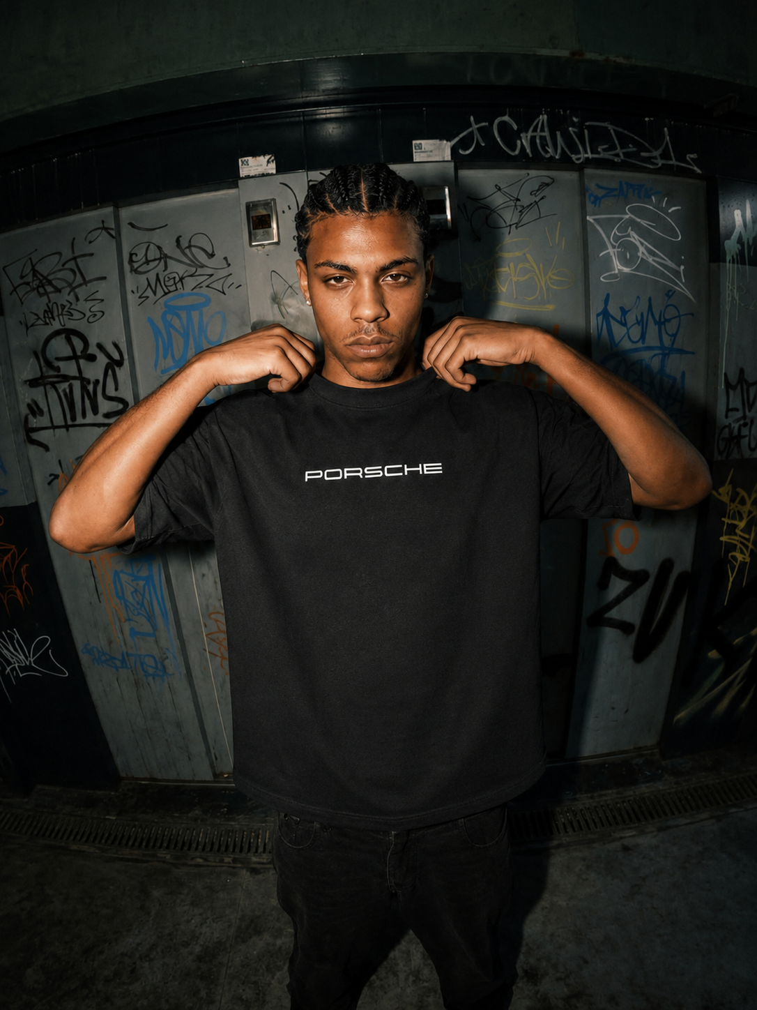 Black Porsche graphic T-shirt with logo on the chest worn by a model
