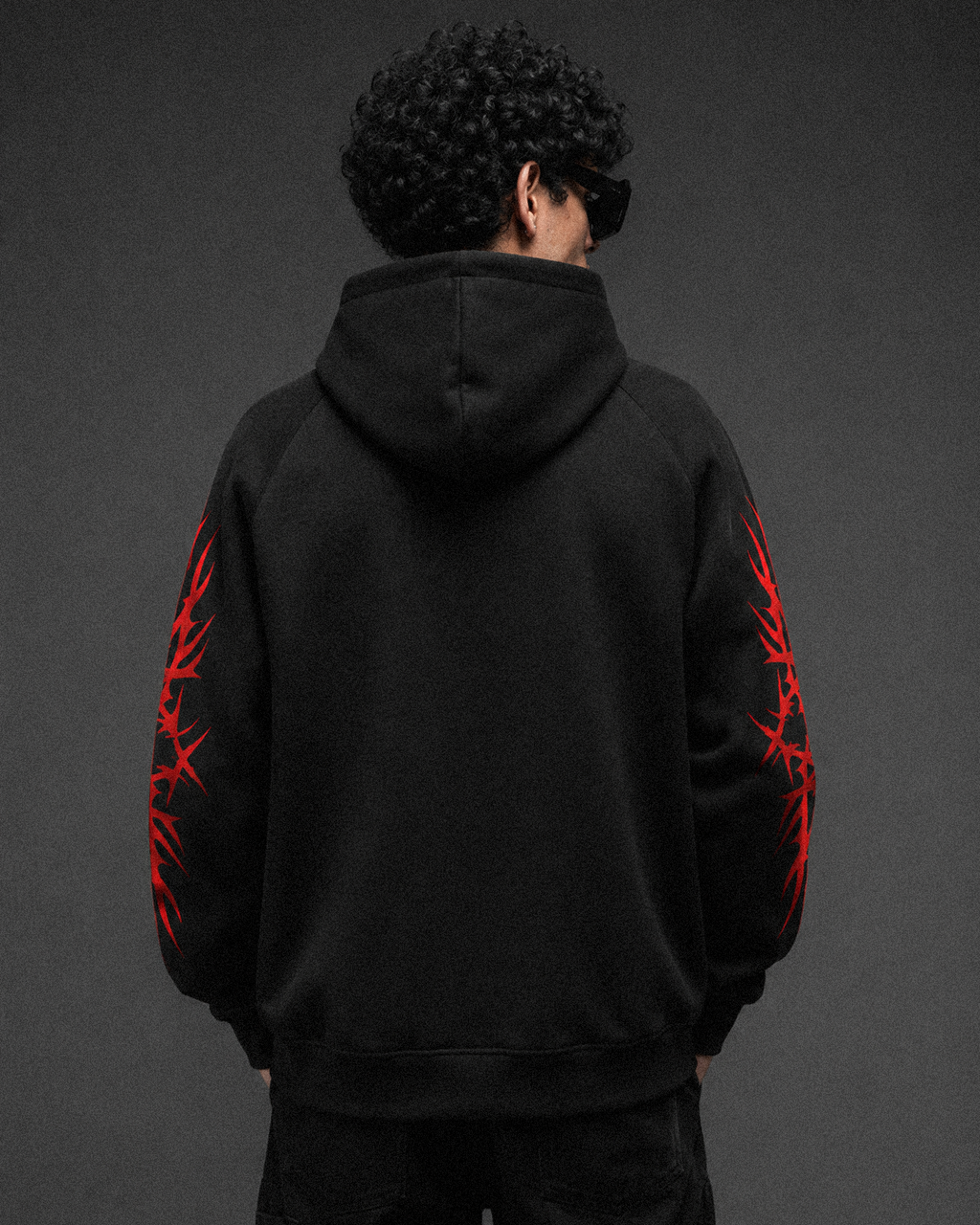 350 GSM oversized hoodie with red tribal graphic prints on both sleeves, back view