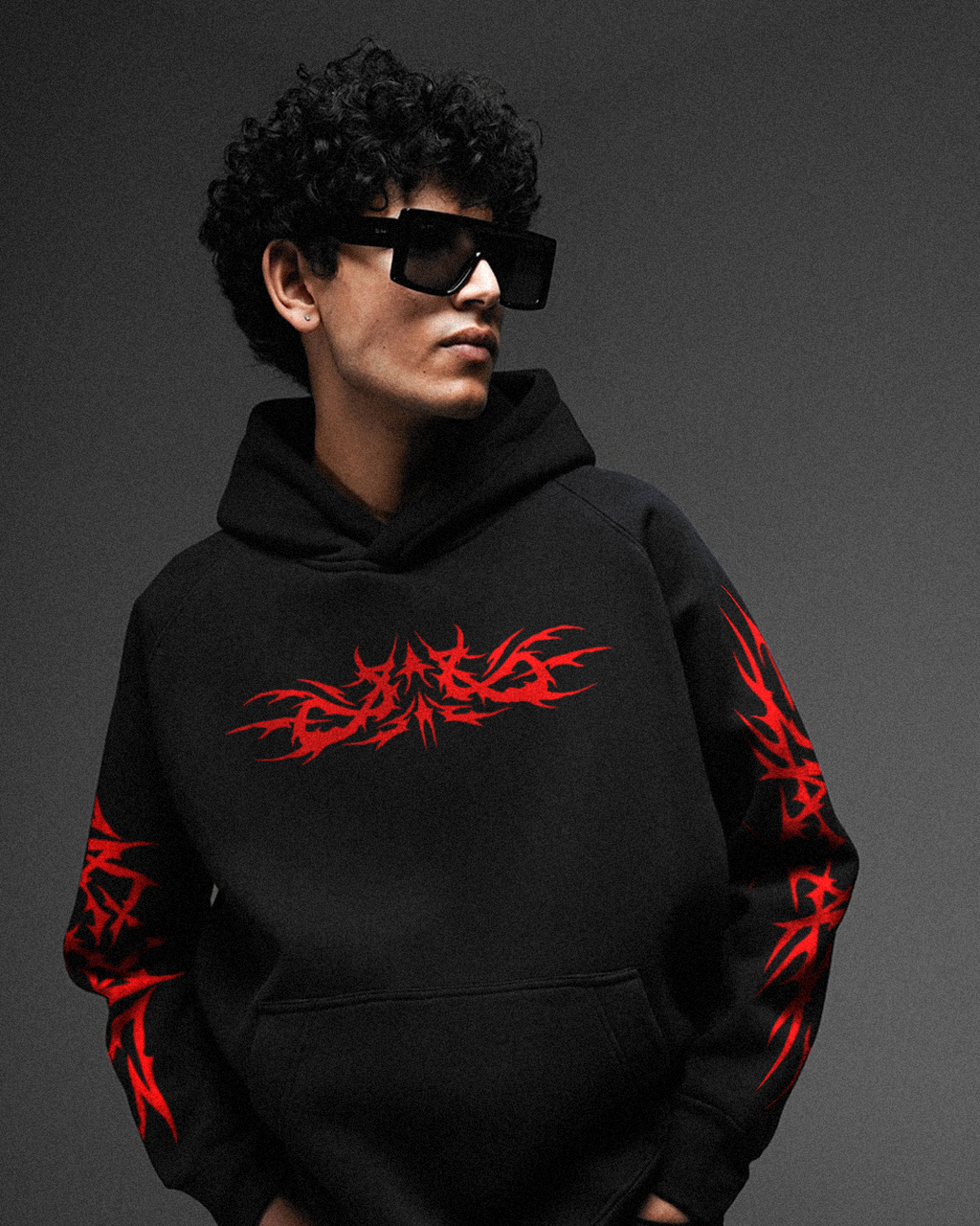 Black 350 GSM oversized hoodie with red tribal graphic print on the chest and sleeves