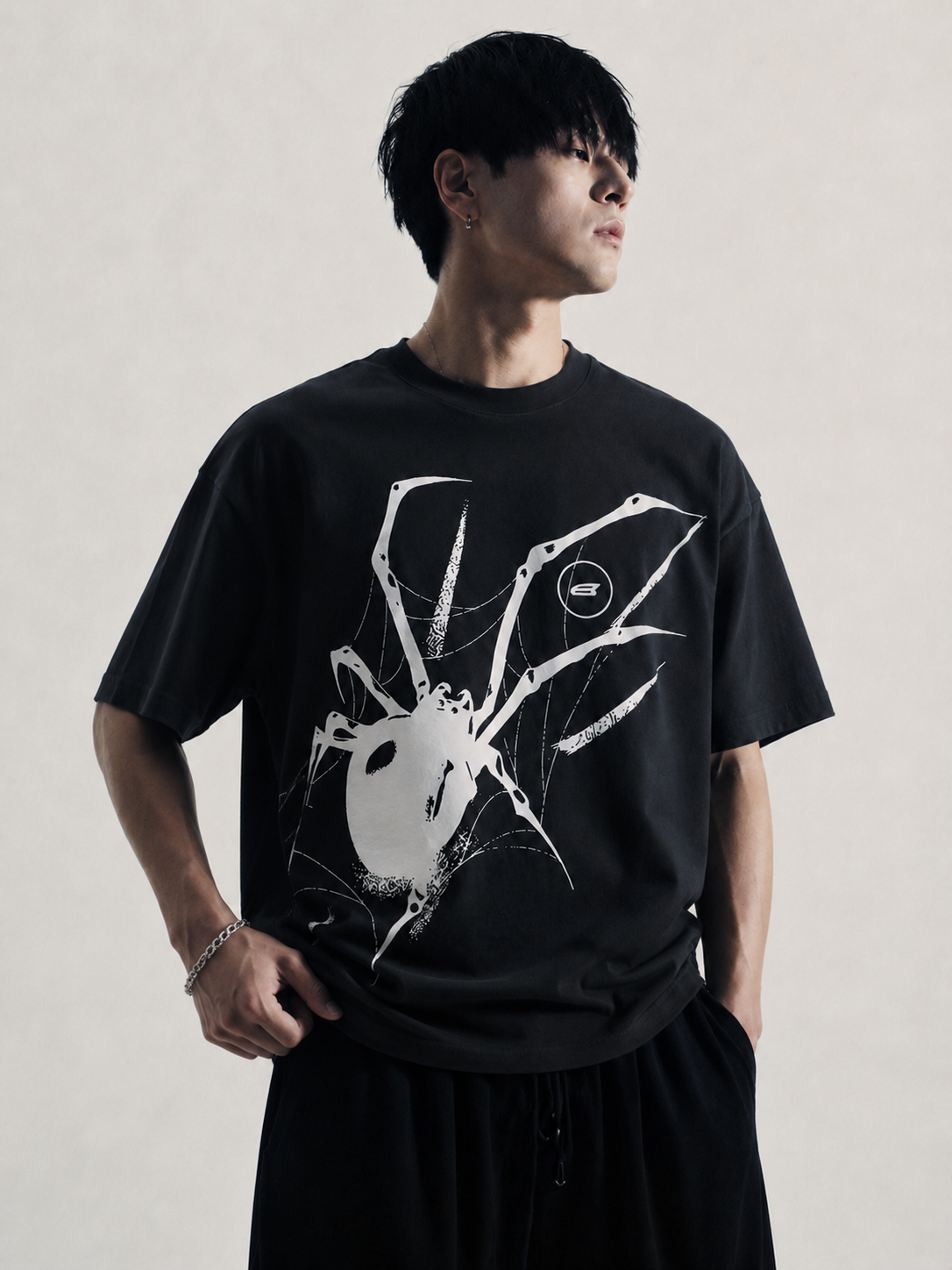 Black oversized t-shirt with large white Y2K spider graphic front print, model wearing the tee